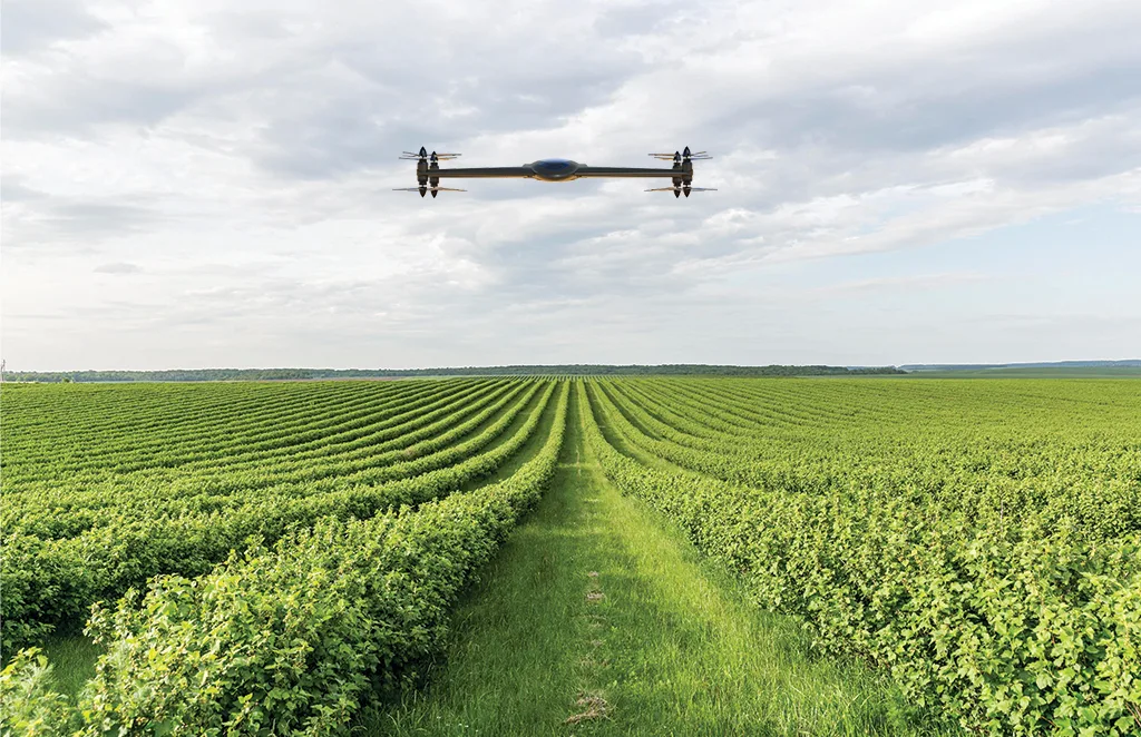A drone flying over a green agricultural field capturing aerial imagery for crop monitoring and analysis