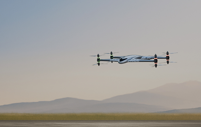 Drone flying low over runway with hazy mountains in the background during sunset