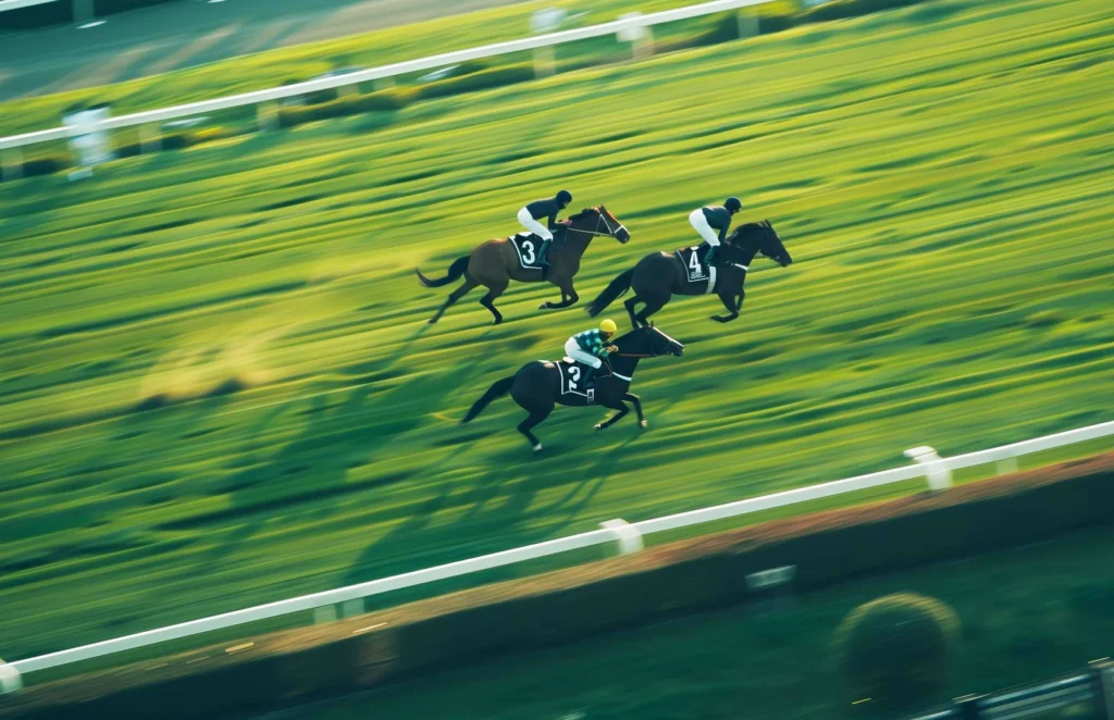 Three jockeys racing horses on a track