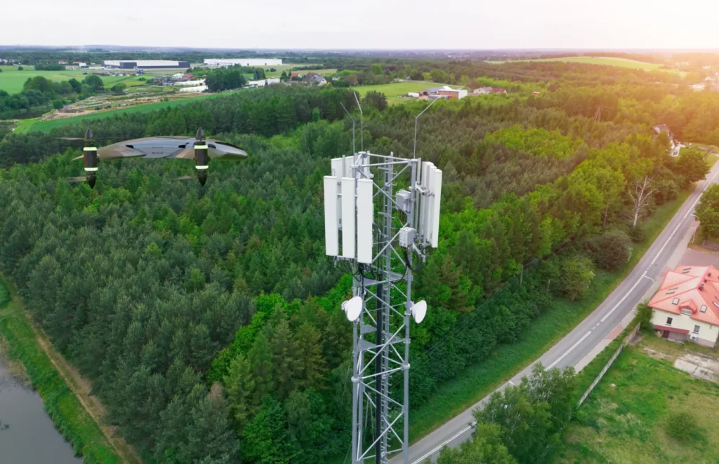 Drone inspecting a telecom tower for network planning and asset auditing