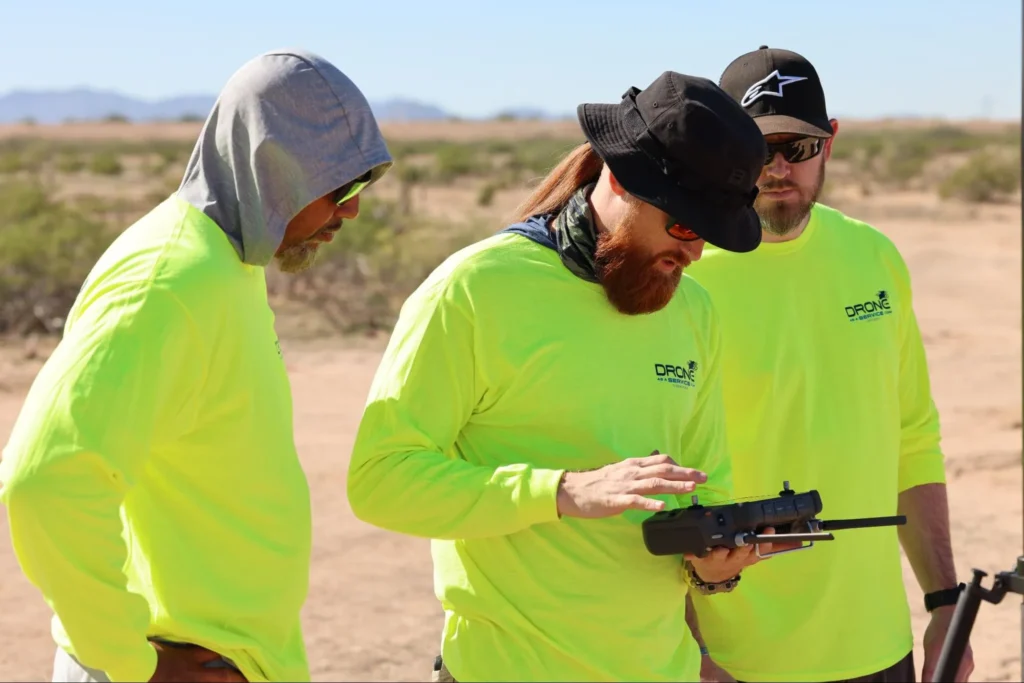 Drone pilots receiving hands-on training and certification support during field operations for DaaS programs